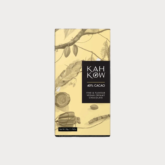 A vertical bar of Kah Ków 40% Cacao chocolate in its packaging, featuring a light beige background with botanical illustrations of cacao branches and leaves, and a black label on the right side.